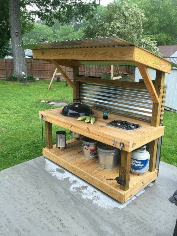 an outdoor cooking station made out of pallets