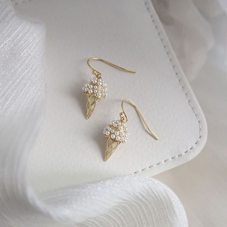 Get ready to satisfy your sweet tooth with these Ice Cream Cone Earrings! Made with sterling silver hoops, these delectable dangles are plated with 14K yellow gold for a touch of elegance. Measuring 3.5cm x 1cm, they feature charming pearl accents for a trendy and unique look. Perfect for any fashionable foodie, these earrings are a playful addition to your summer accessory collection. Silver 14k Gold Filled Hoop Earrings For Gift, Silver 14k Gold Filled Hoop Earrings As Gift, Trendy Gold Plated Earrings For Gifts, Gift Pearl Earrings With Metal Plating, Metal Pearl Earrings With Plating For Gifts, Metal Plated Pearl Earrings For Gifts, Hypoallergenic Gold Plated Earrings For Anniversary, Dangle Earrings With Plating As Gift, 14k Gold-filled Silver Earrings As Gift