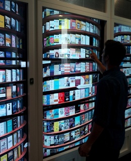 a man standing in front of a large display of books