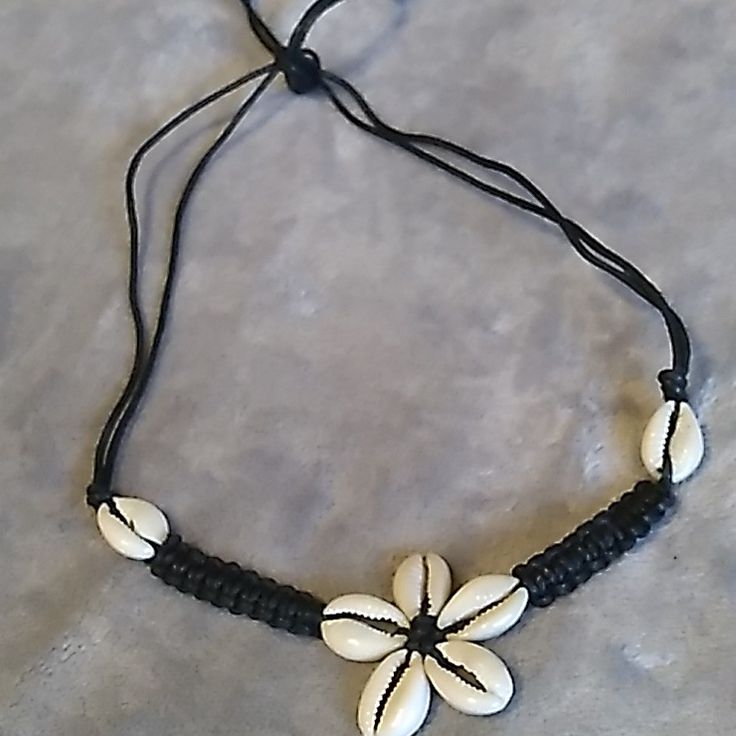 Handcrafted Cowrie Shell Flower Necklace Adjustable Necklace Ties In Back 9" Longest Length For Necklace, Can Adjust Down. Tags, Macrame, Crochet, Braided. Cowrie Shell Symbolizes Wealth & Fertility. Adjustable Bohemian Flower Necklace, White Flower Jewelry For Vacation, Handmade Black Flower Necklace, Adjustable Flower Necklace For Beach, Bohemian White Flower Necklace For Beach, Handmade Adjustable Flower Necklace For Beach, Black Necklaces For Vacation, Black Vacation Necklaces, Black Bohemian Flower Necklace