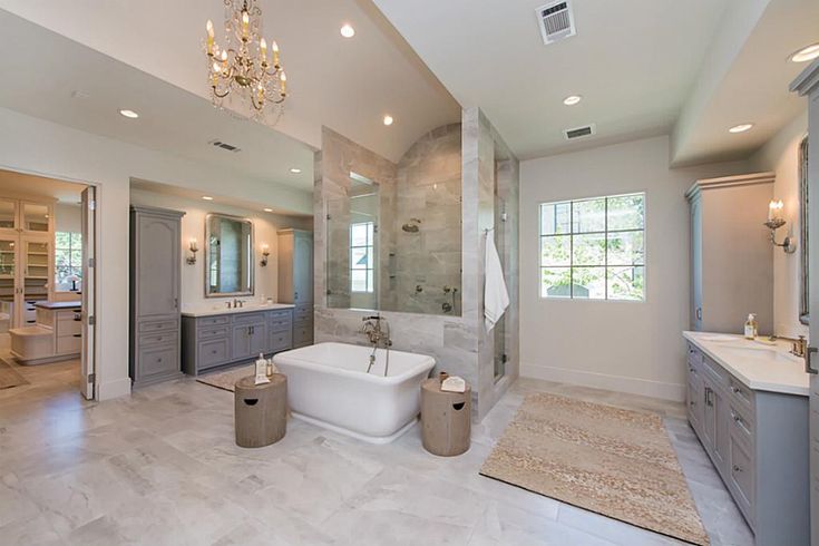 a large bathroom with two sinks and a bathtub next to a walk in shower