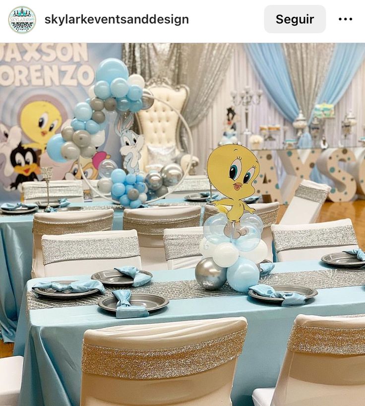 a table set up for a baby's first birthday party with balloons and decorations