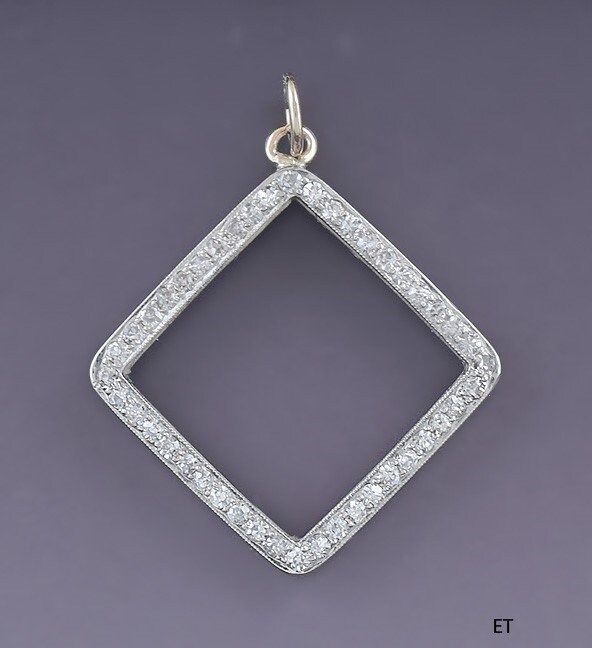 Presented is a gorgeous 14 karat white gold and diamond pendant. This piece is of relatively modern make, likely made in America. The pendant is done in an open square or diamond shape, bead set with 44 single cut diamonds. The diamonds are SI-2 to I-1 clarity and H color. The total diamond weight is about 44 points, or slightly shy of half a carat. The pendant is in excellent condition. The diamonds are all intact . The pendant is not stamped or hallmarked but we have tested it with nitric acid Diamond White Square Pendant With Single Cut Diamonds, Diamond White Jewelry With Single Cut Square Pendant, Diamond White Square Pendant Jewelry, White Gold Square Diamond Jewelry, Square White Gold Diamond Jewelry, Silver Square Cut Single Diamond Jewelry, Silver Jewelry With Single Cut Square Diamonds, Square Diamond Cut Jewelry, Rectangular Diamond Necklace In White Gold