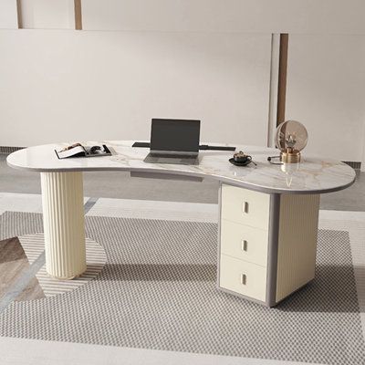 an office desk with a laptop on it in a room that has carpeted flooring