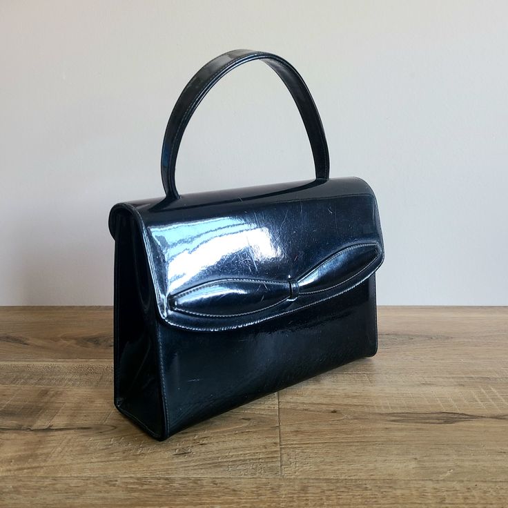 Vintage black patent leather Mastercraft bag. Evening purse 1960s. Made in Canada. 6.5'' tall (without strap), 9'' wide, 2 3/4'' deep. Artificial leather lining. Has a surface scratch on the front and couple small marks on the back. Overall is good condition. Very pretty little purse. Save on shipping when you buy multiple items from my shop! Sugar Bowls And Creamers, Evening Purse, Lovely Necklace, Artificial Leather, Black Patent Leather, Purses And Handbags, Vintage Black, Patent Leather, 1960s