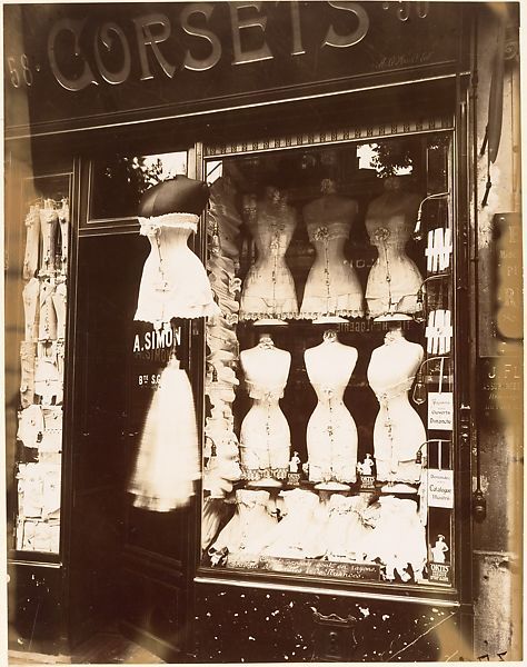 an old fashion store front with mannequins on display