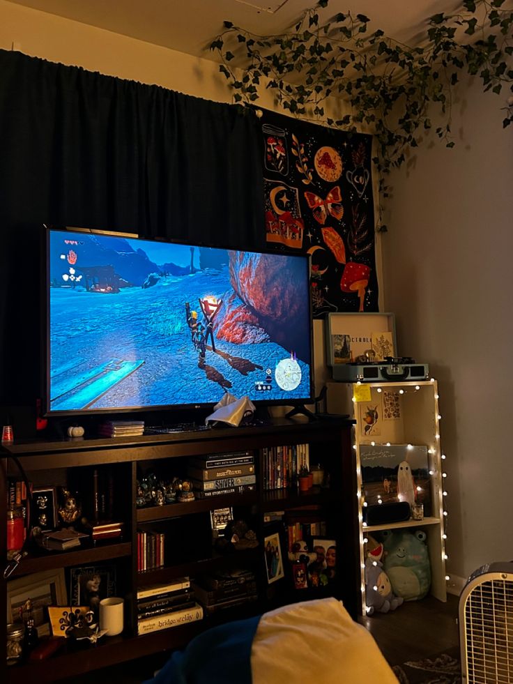 a flat screen tv sitting on top of a wooden entertainment center