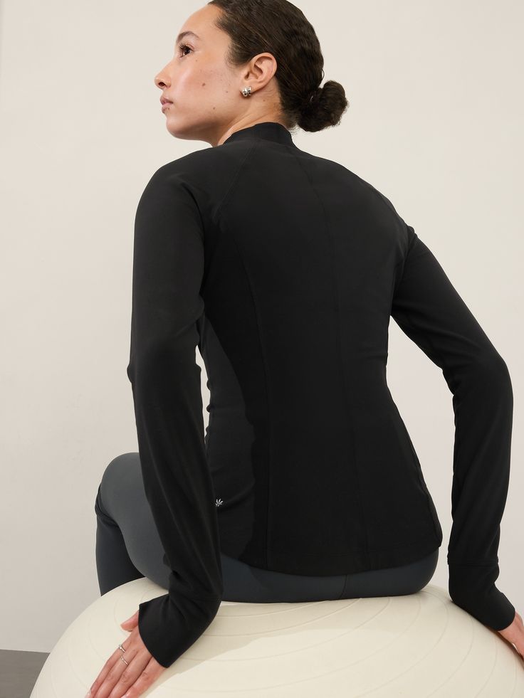 FOR: Yoga or studio practice FEEL: Textured fabric is cozy with gentle compression FAVE: Easy-access side pockets to stash your essentials Fitted next to the body Regular length, hits at low hip Half zip Body length in size medium: Regular: 25" Body length in size Plus/2X: Regular: 27". Functional Solid Activewear With Thumbholes, Fitted Technical Activewear With Built-in Padding, Fitted Yoga Top With Built-in Padding, Functional Activewear With Thumbholes For Training, High Stretch Tops With Built-in Padding For Pilates, Fitted Technical Activewear, Fitted Solid Color Technical Activewear, Versatile Fitted Moisture-wicking Activewear, Functional High Stretch Activewear With Thumbholes