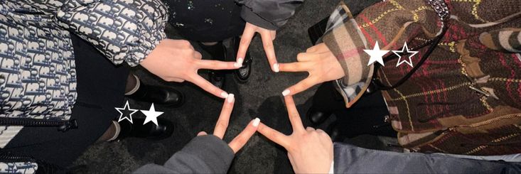 four people holding their hands in the shape of five stars with white writing on them