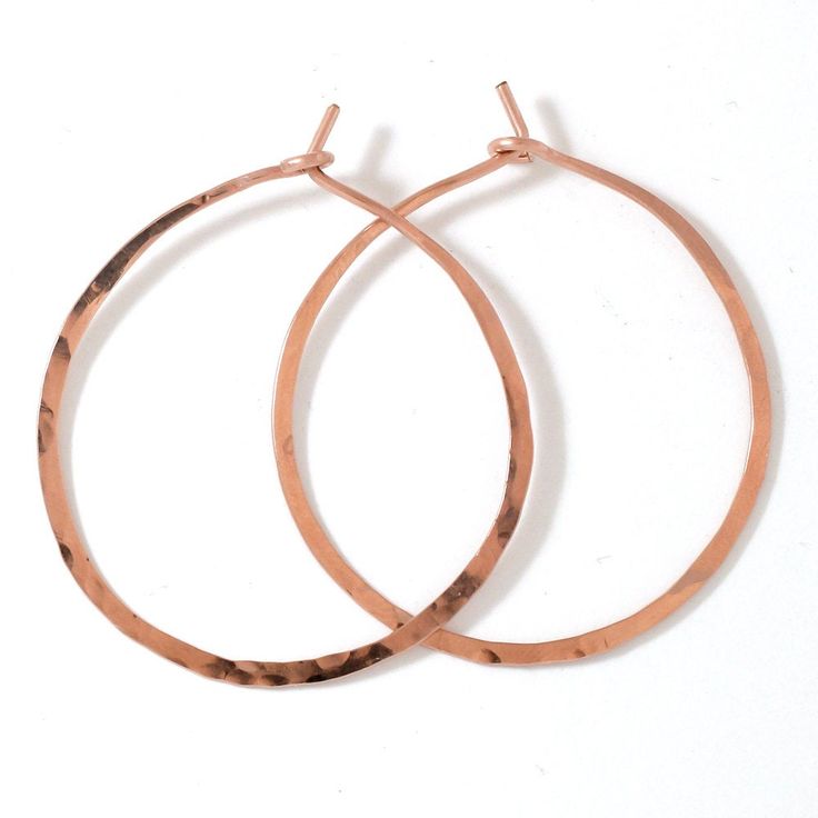 "These delicate hand crafted 14k gold filled, sterling silver, or rose gold filled hoops are hand shaped, filed, forged and polished to a glittering finish. The high quality metal will never turn no matter how much you wear them - just clean them with some windex or warm soapy water and they're good to go! They measure 1.5\" in diameter, are virtually weightless, and close with a loop in the back. These earrings are in it for the long haul : we only use high quality 14k gold filled and rose gold Handmade Rose Gold Hoop Earrings For Gift, Copper Hammered Hoop Earrings As Gift, Hammered Copper Hoop Earrings As Gift, Adjustable Nickel Free Rose Gold Hoop Earrings, Rose Gold Nickel-free Small Hoop Earrings, Hammered Rose Gold Sterling Silver Hoop Earrings, Rose Gold Hammered Sterling Silver Hoop Earrings, Handmade Rose Gold Hoop Jewelry, Nickel Free Rose Gold Hoop Earrings For Gift