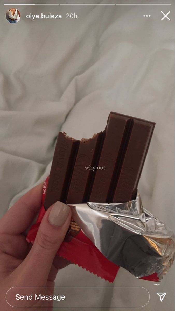 someone is holding a chocolate bar in their hand and it looks like they are eating something