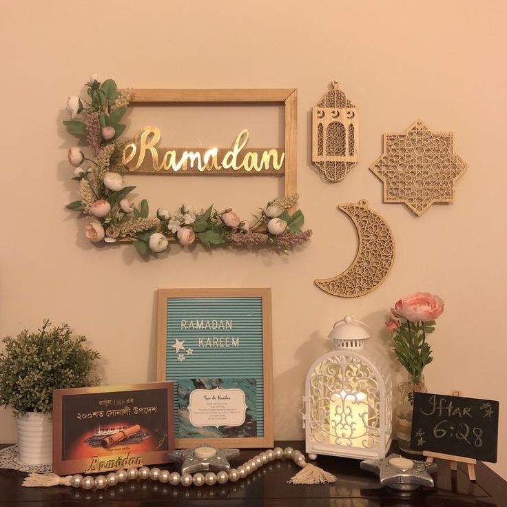 a table topped with lots of decorations and framed pictures next to a wall mounted sign