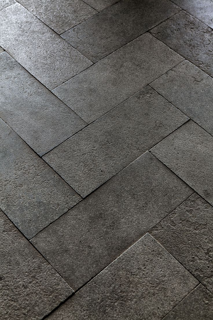 a person riding a skateboard on top of a stone flooring pattern in the city