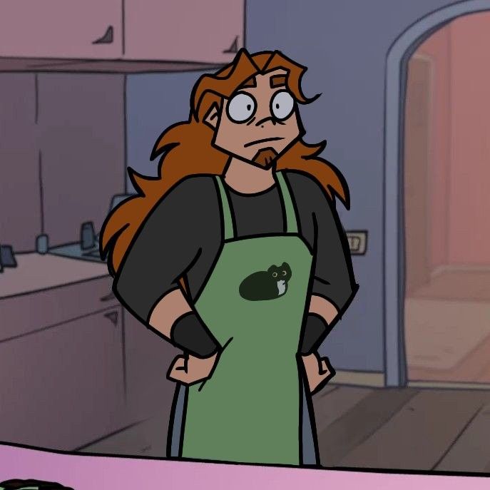 a woman in an apron standing next to a counter