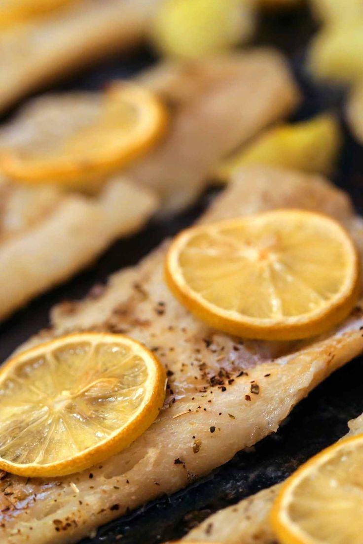 grilled fish with lemon slices on the side