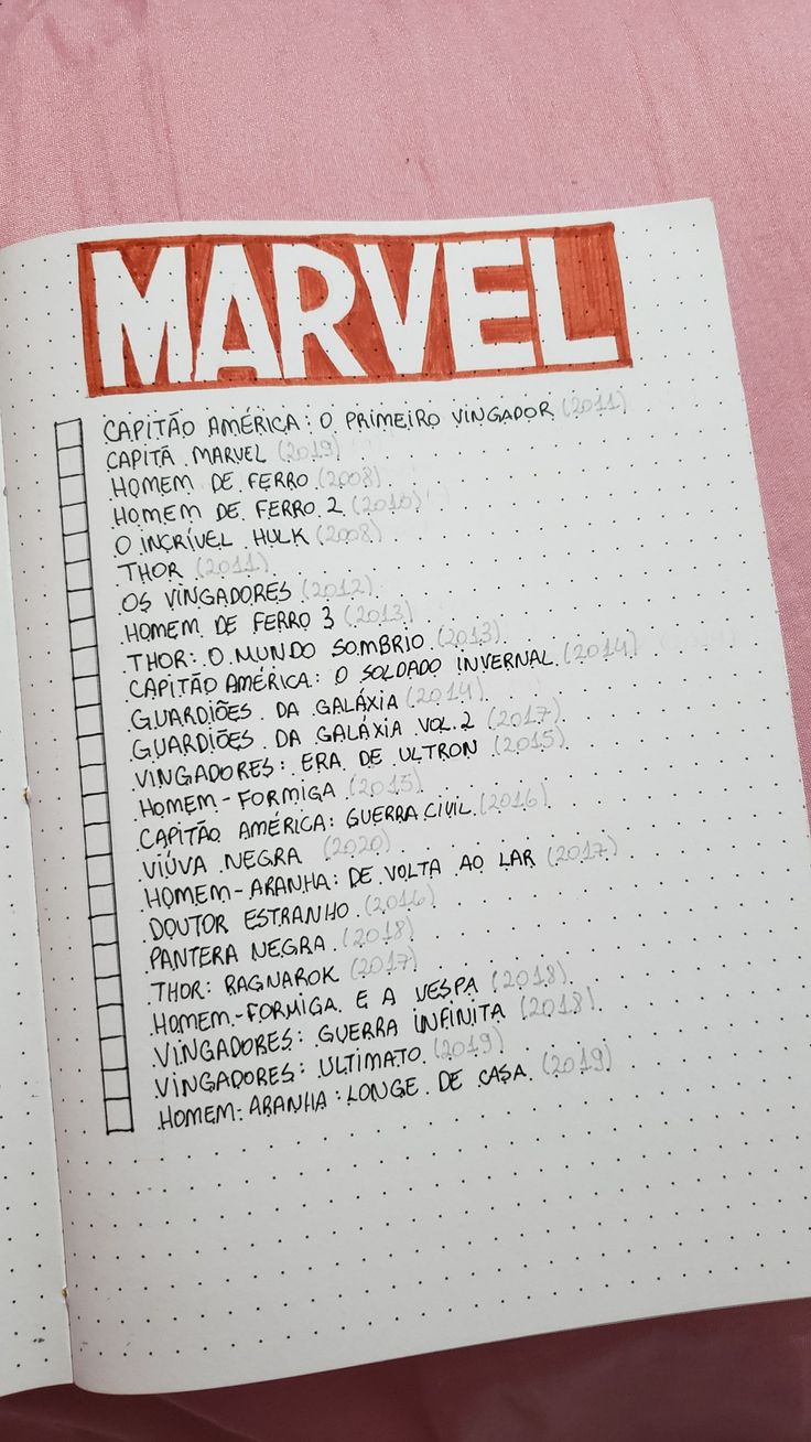 an open notebook with the words marvel written in red and black on top of it