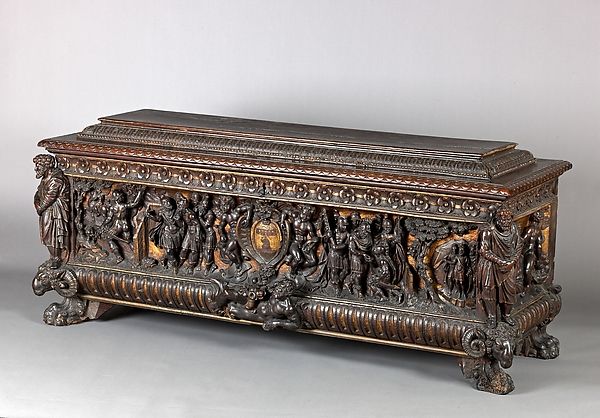 an ornate wooden box with carvings on it