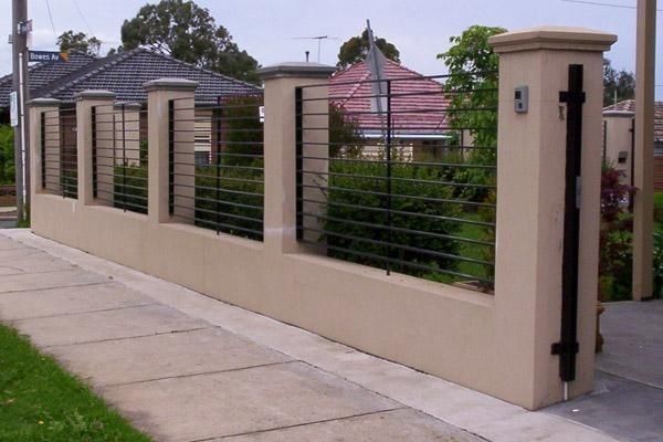 a fence that is next to a sidewalk