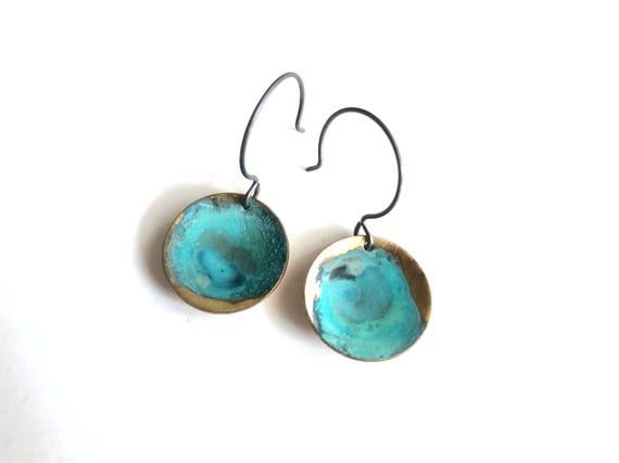 Brass naturally oxidized with Verdigris patina. Hangs from oxidized sterling silver ear wires.Measurement:1/2”x1”Care:All of our patina pieces are sealed with a resin lacquer to help protect the oxidization, however we do recommend that you keep all patina pieces dry and away from water as it can further the oxidation process and potentially can alter the color. *Patina is a natural oxidation process so color shades may vary. Hand Forged Blue Round Earrings, Hand Forged Artsy Earrings For Gifts, Artsy Hand Forged Earrings For Gift, Artsy Hand Forged Earrings As Gift, Artsy Green Patina Jewelry, Artsy Bronze Jewelry With Patina, Artsy Patina Bronze Jewelry, Green Oxidized Finish Earrings For Gift, Artisan Drop Earrings With Patina