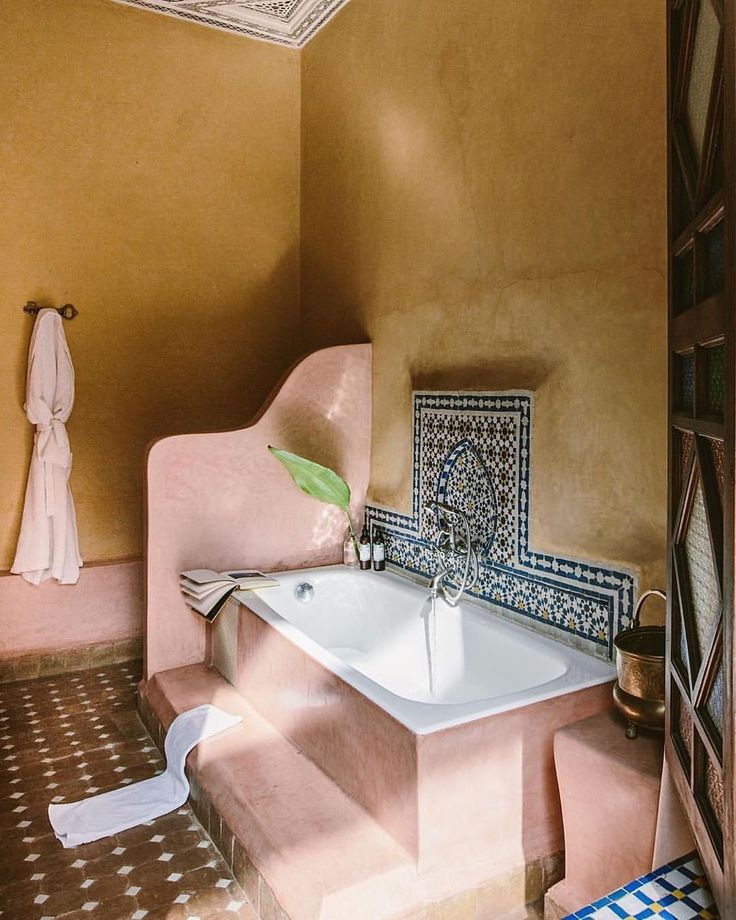 a bath room with a tub and a sink