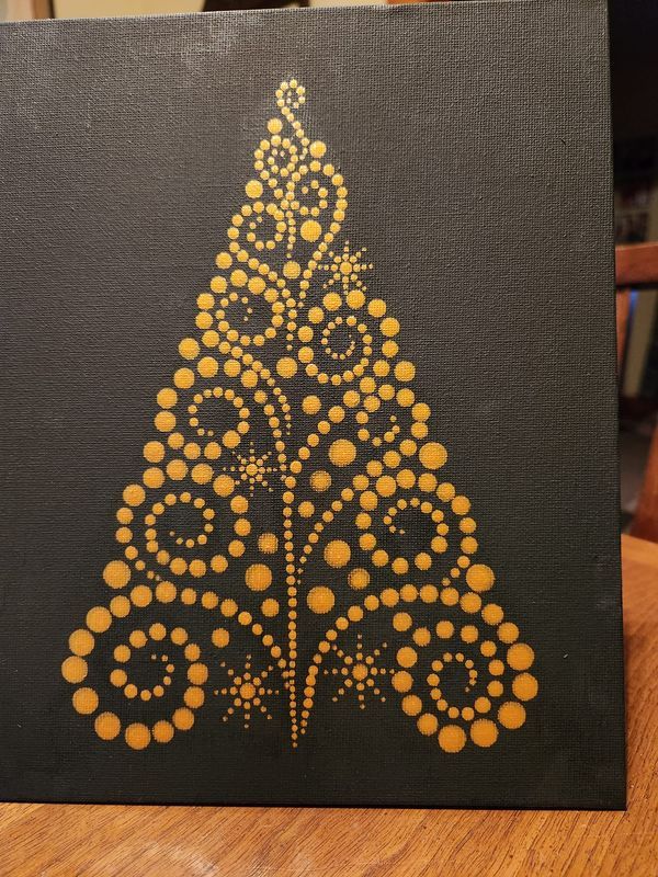 a black and gold christmas tree painted on a canvas with circles in the shape of dots