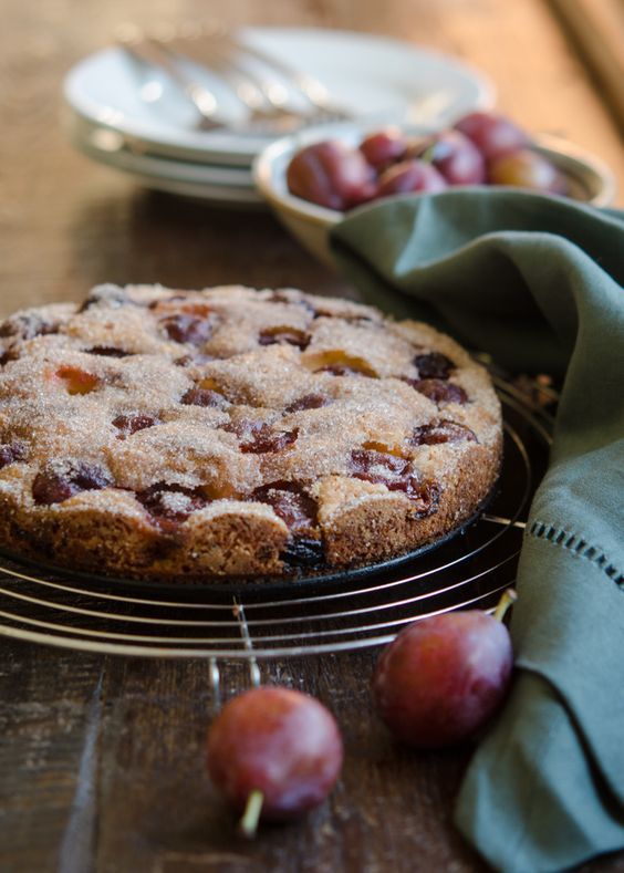 a cake on a cooling rack next to some fruit