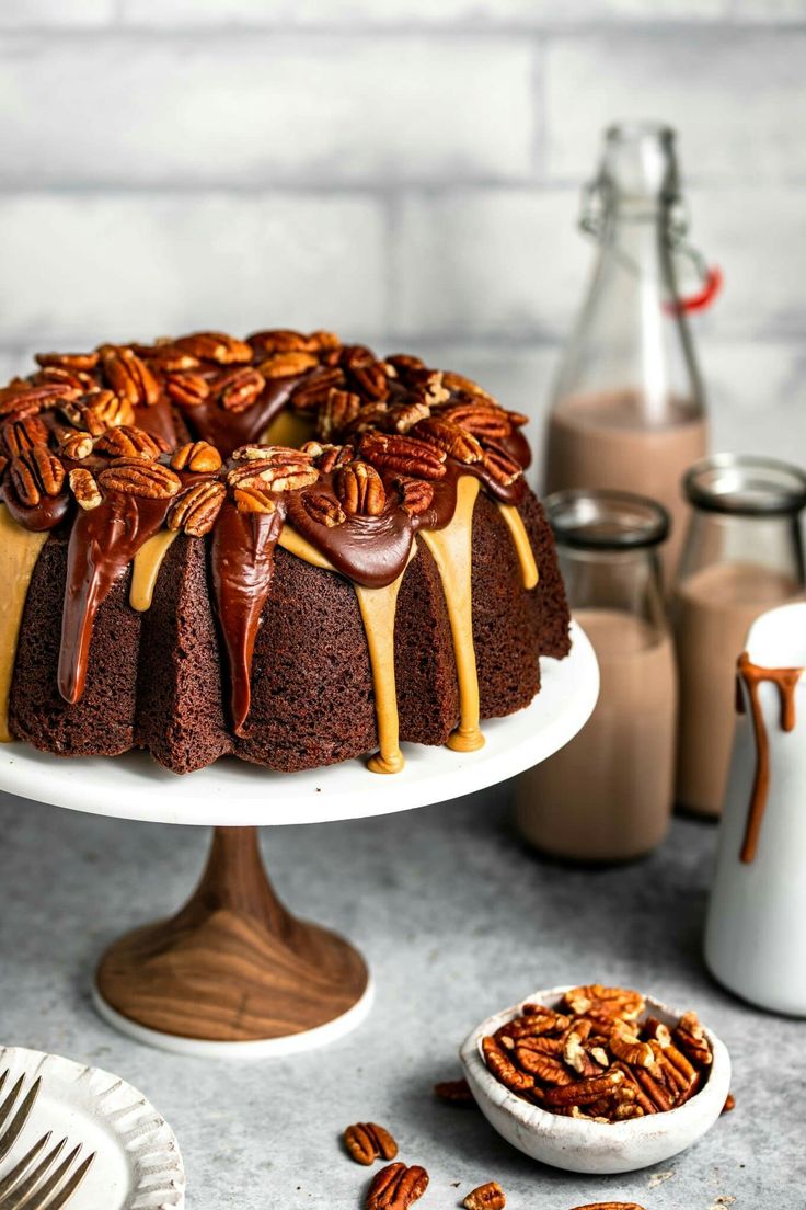 a bundt cake with pecans and caramel drizzle on top