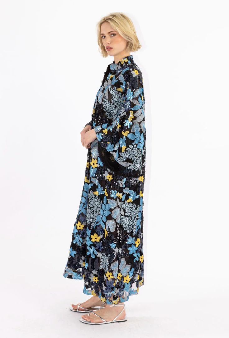 Slip on our signature caftan silhouette for an effortless look that feels refined. this caftan features sequin embroidered florals in blue hues, with golden florals peeping throughout. handmade. banded collar. bell sleeves. bust: 50", hem opening: 69", sleeve opening: 38", body length: 51" four button placket. dry clean. see-through. pictured with undergarments. sales promotions not applicable to outside partners. Model is 5'9" / 175cm. this item is only available in one size. Silk Kaftan With Floral Embroidery And Long Sleeves, Floral Print Long Sleeve Kaftan For Daywear, Blue Floral Print Kimono For Fall, Bohemian Floral Print Evening Kaftan, Elegant Blue Floral Print Kaftan, Blue Long Sleeve Kimono With Floral Embroidery, Spring Evening Embroidered Kaftan, Blue Floral Print Long Sleeve Kaftan, Blue Long Sleeve Kaftan With Floral Print