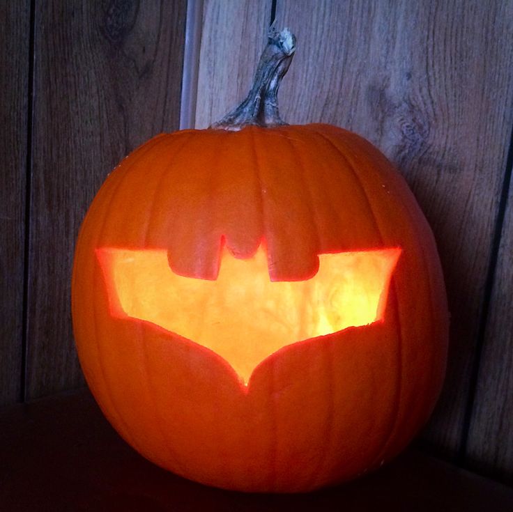 a carved pumpkin with the batman symbol on it