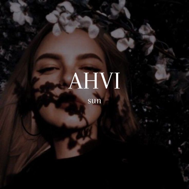 a girl with flowers in her hair and the words ahvi sun above her face