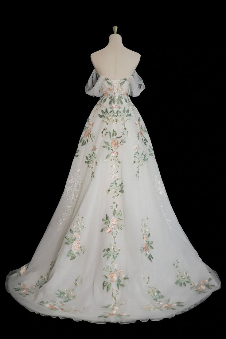 a white wedding dress with flowers on it