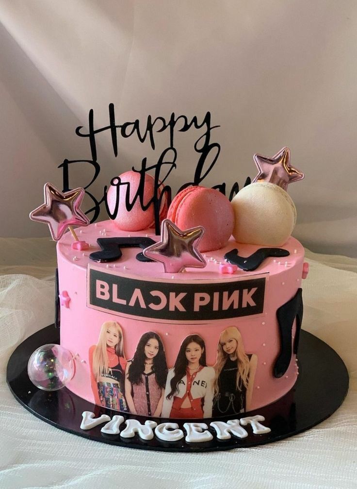 a birthday cake decorated with pink and black icing, stars, and the words happy birthday written on it