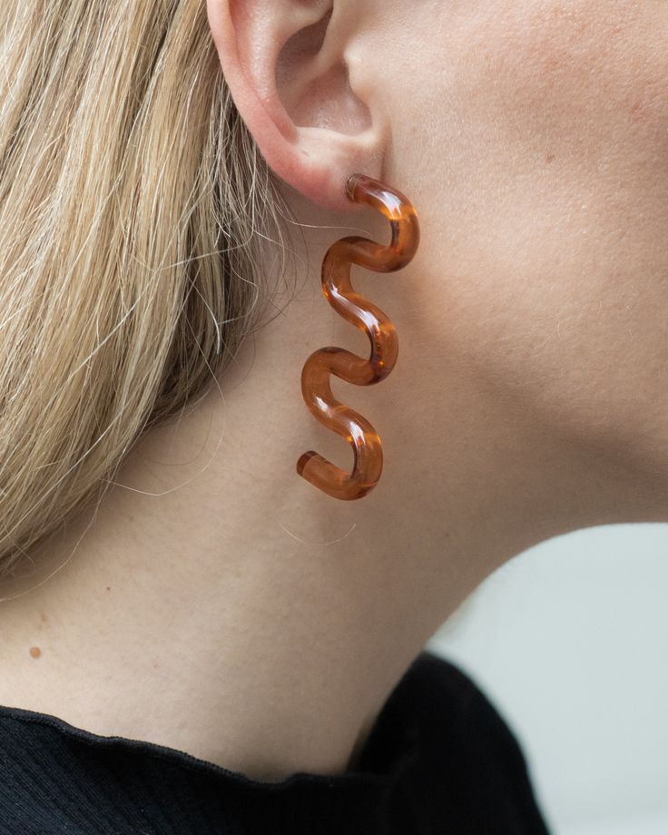 [let those ripples glide right through you]These squiggly wavey ripple curly caramel earrings are just as fun as you. Take them out on the town and show them a good time, all while receiving all the compliments. MATERIAL: Resin with Stainless Steel Push Back (hypoallergenic) WEIGHT: Light COLOR: Clear BrownLength: 2.8in (70mm) Width: 1.6in (40mm) Good Time, Ocean Waves, Vintage Shops, Light Colors, Ear Cuff, Caramel, Color