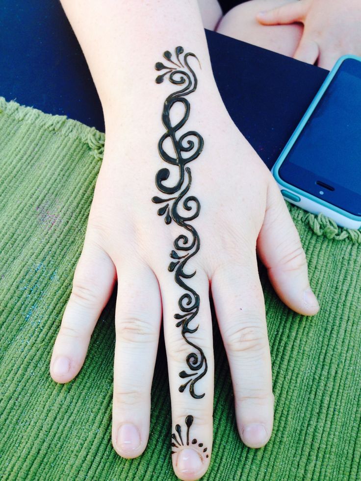 a woman's hand with a henna tattoo on her left hand and the word love