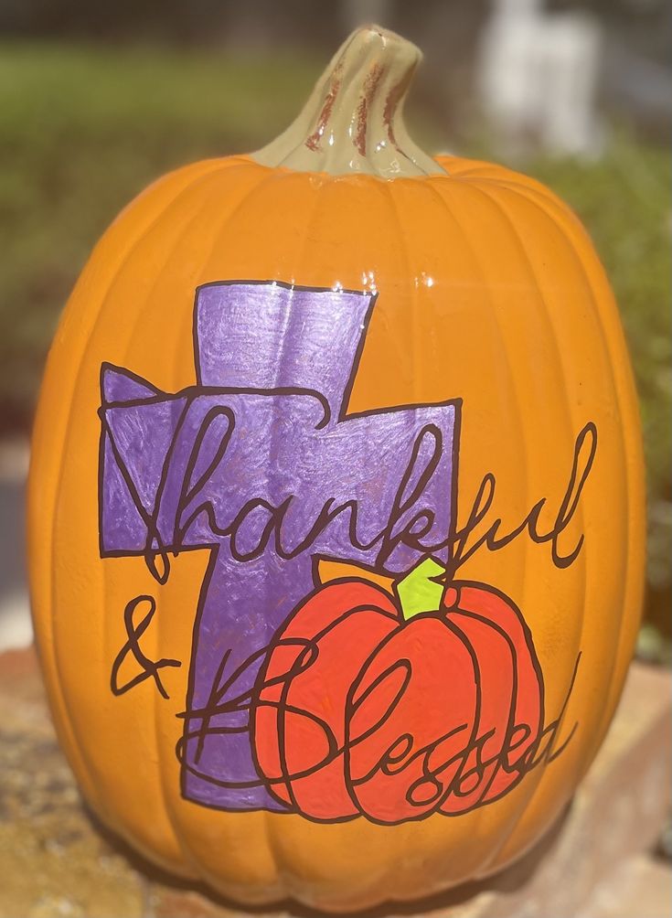 a painted pumpkin with the words, thank and jesus on it