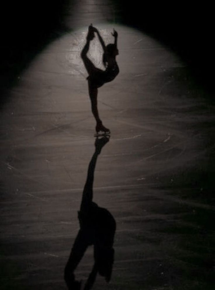 a person doing a trick on a skateboard in the dark