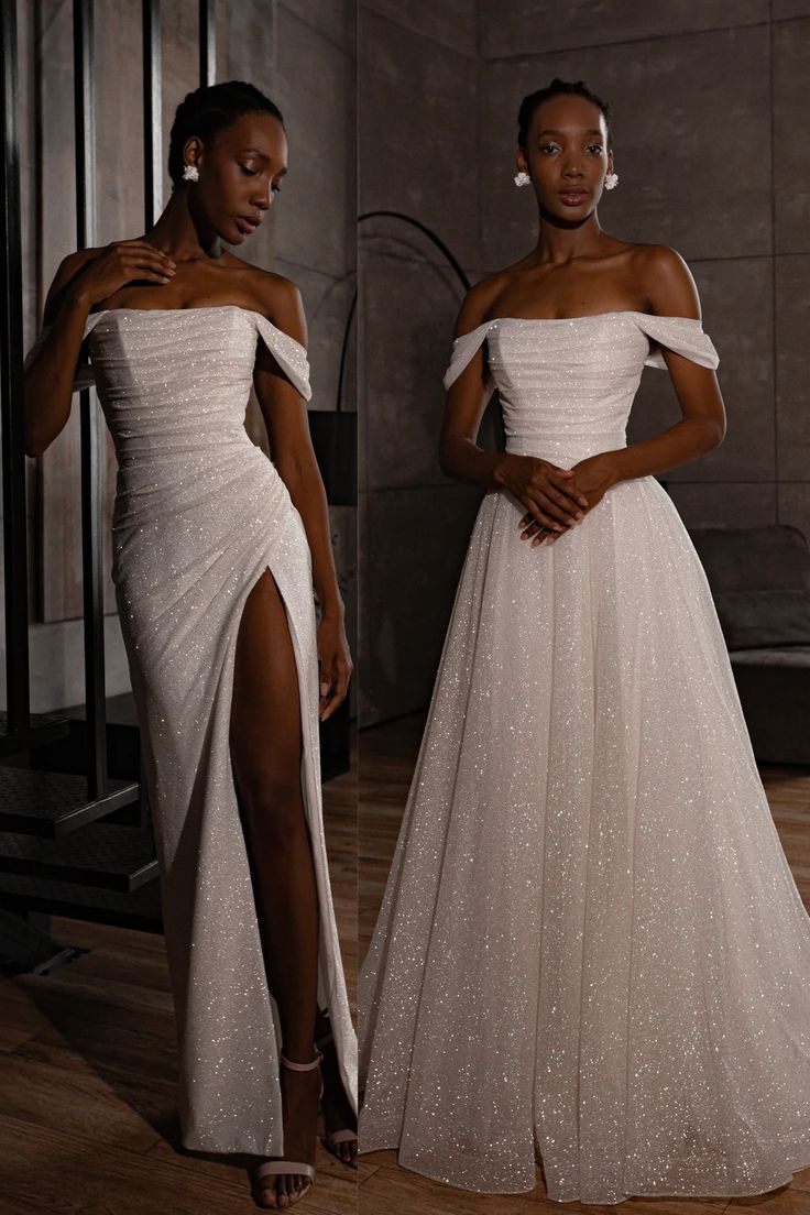 two women in white dresses standing next to each other, one is wearing a high slit skirt