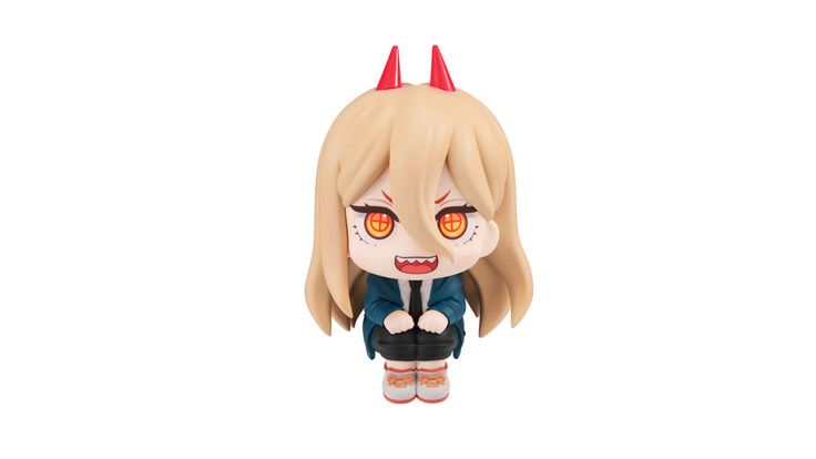 an action figure with horns on it's head and eyes, sitting in front of a