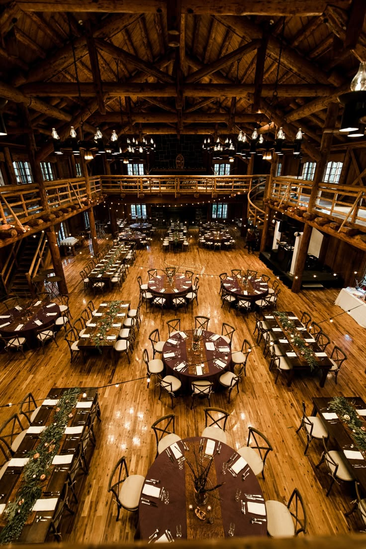 the inside of a large building with tables and chairs set up for an event or function