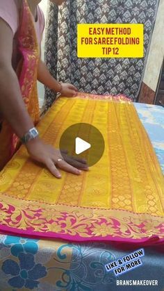 a woman is making a yellow and pink saree