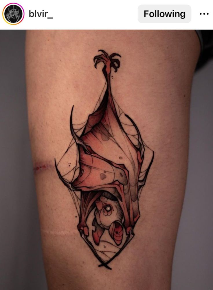 a woman's thigh with an artistic tattoo design on it