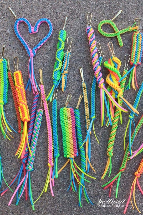 many different colored pieces of string with heart shaped decorations attached to them on the ground