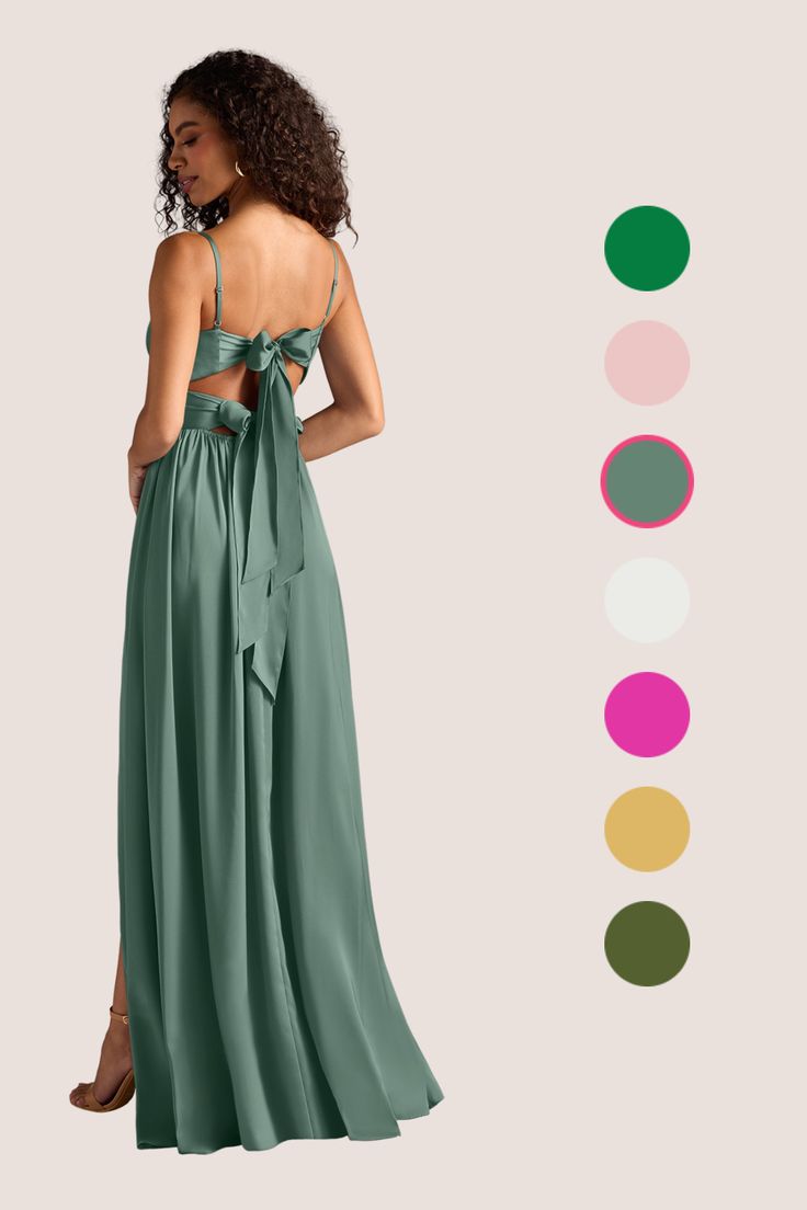 a woman wearing a green dress with an open back and bow at the waist, standing in front of color swatches