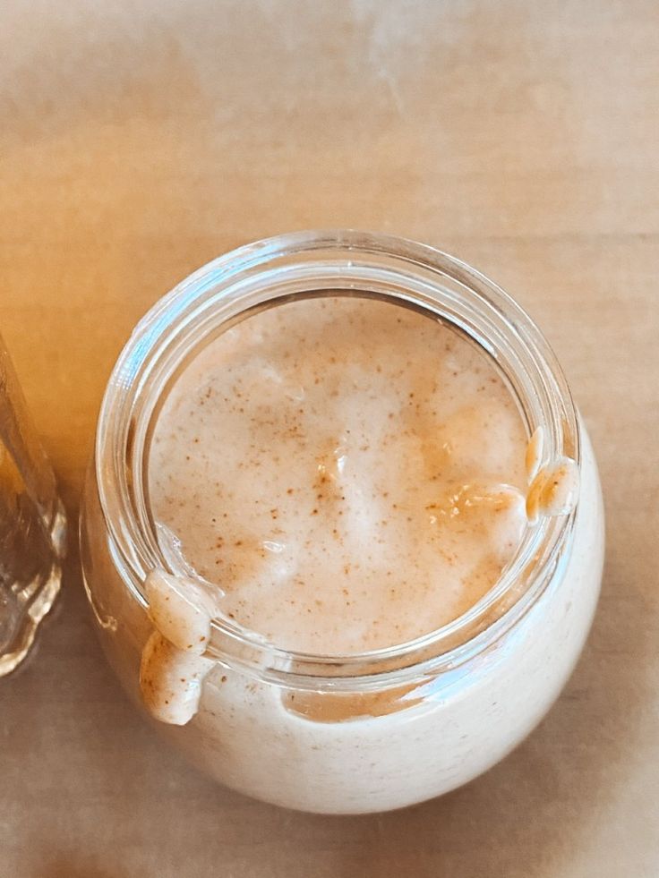 a glass jar filled with liquid sitting on top of a table