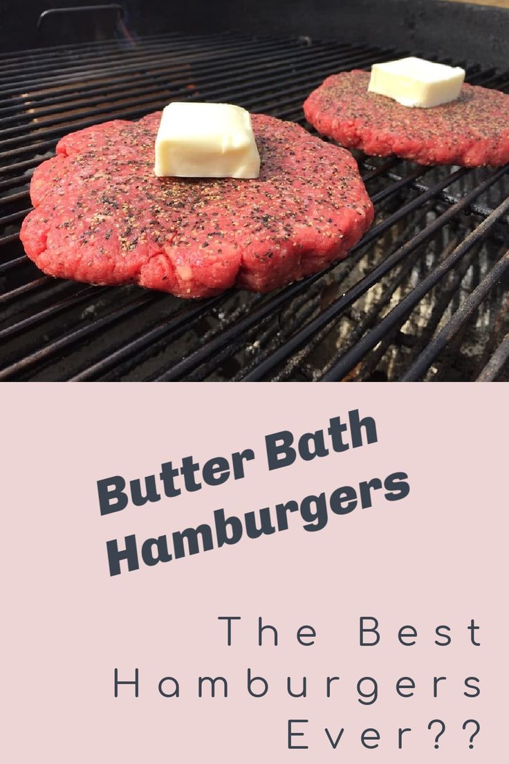 two hamburger patties cooking on the grill with butter