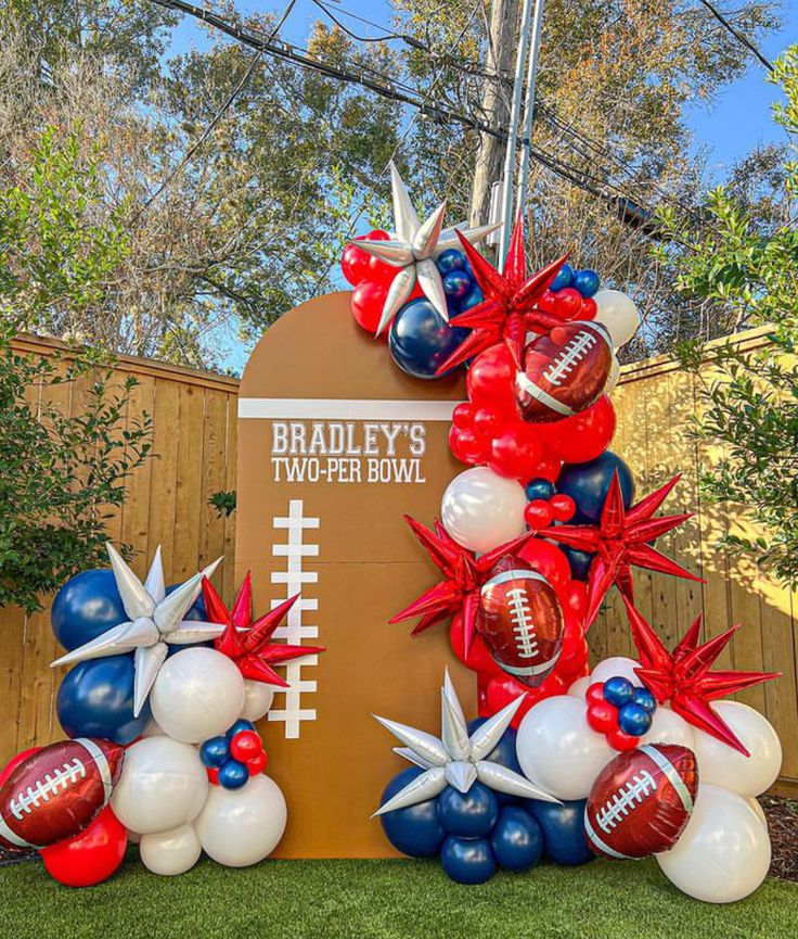 balloons and footballs are on display in front of a sign for bradley's two - eleven bowl