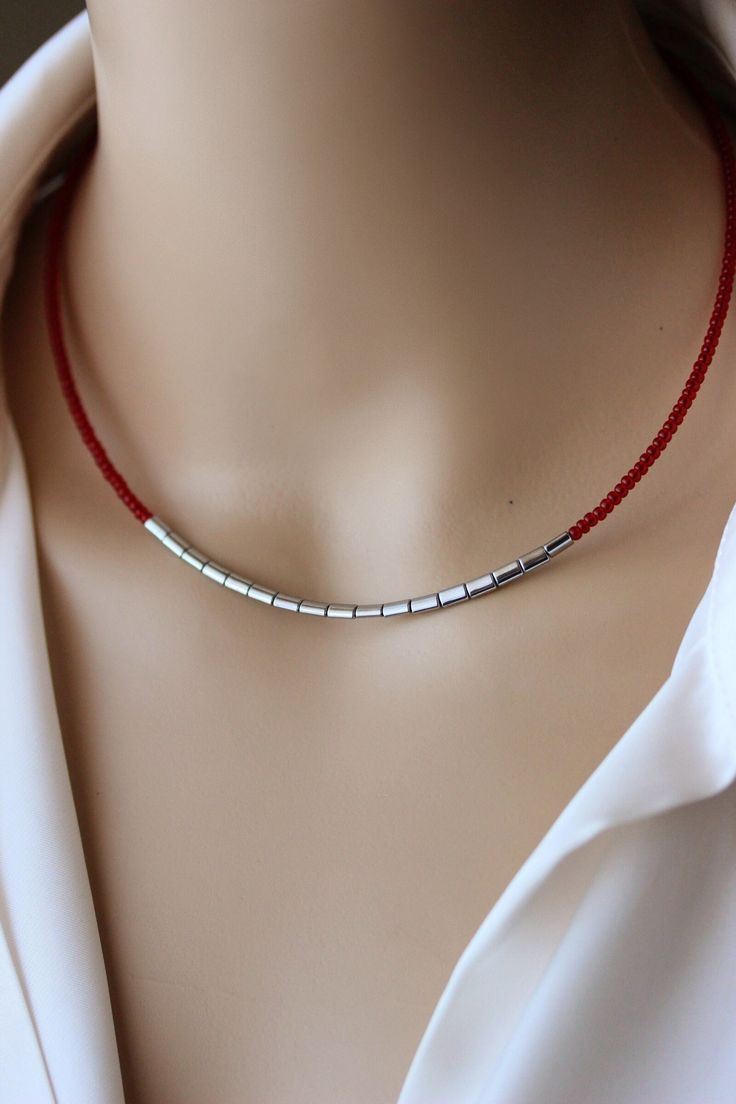 This trendy minimalist choker necklace was made of red glass seed beads, silver tone hematite stone beads, two layers of strong nylon thread, stainless steel end clasps, stainless steel lobster claw and stainless steel chain. Perfect jewelry for everyday wear! PLEASE NOTE: The silver tone pendant necklace is not included in the price and serves as an example of how you can combine other necklaces with this short necklace, but it is also available in my store. The length of necklace is about 41.5 Seed Bead Necklace Diy, Seed Beads Necklace, Beads Choker, Red Beaded Necklaces, Diy Jewelry Inspiration, Beaded Necklace Diy, Hematite Stone, Red Necklace, Silver Bar