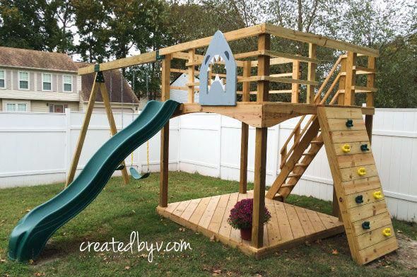 a wooden play set with a slide and climbing frame