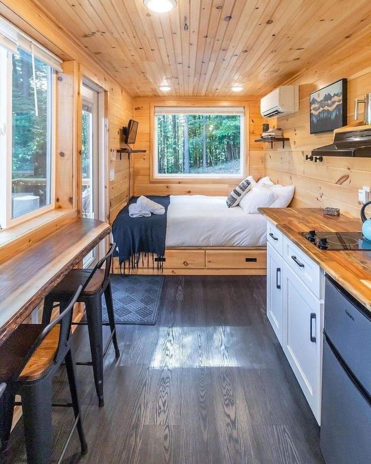 a bedroom and kitchen in a tiny cabin