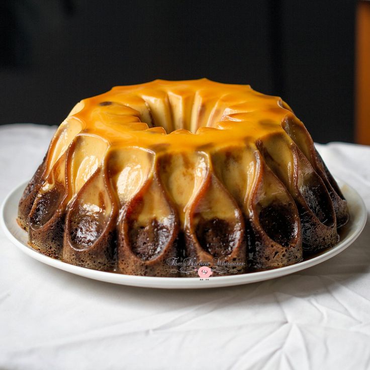 a bundt cake with caramel drizzled on top sitting on a white plate